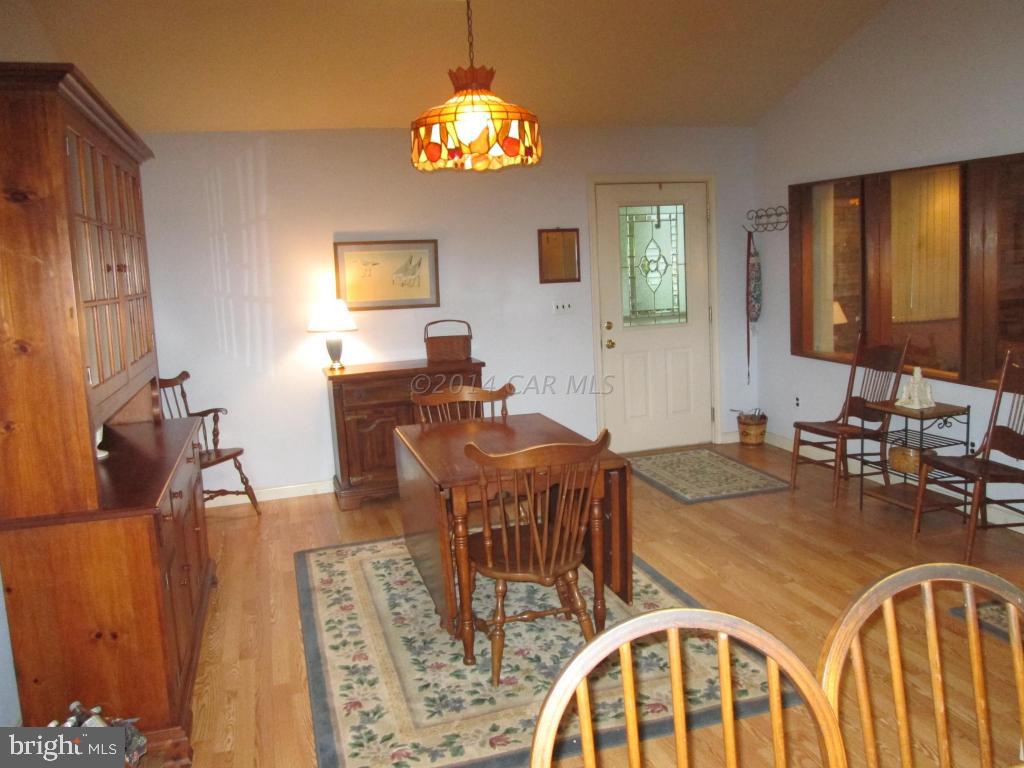 165 Windjammer Road Berlin, MD 21811 - Photo 11 of 26 a view of a dining room with furniture