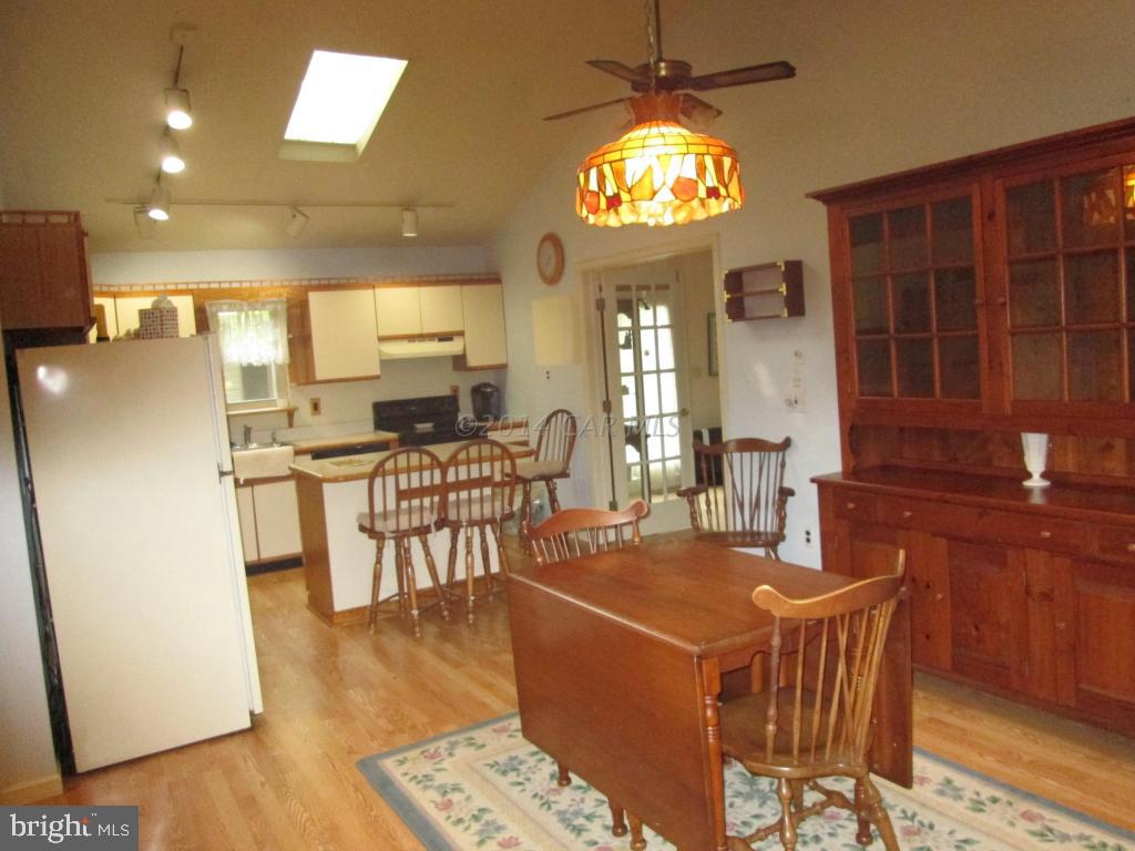 165 Windjammer Road Berlin, MD 21811 - Photo 12 of 26 a view of a dining room with furniture and chandelier