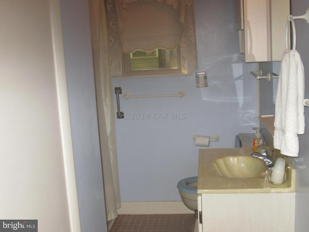 165 Windjammer Road Berlin, MD 21811 - Photo 13 of 26 a bathroom with a sink and toilet