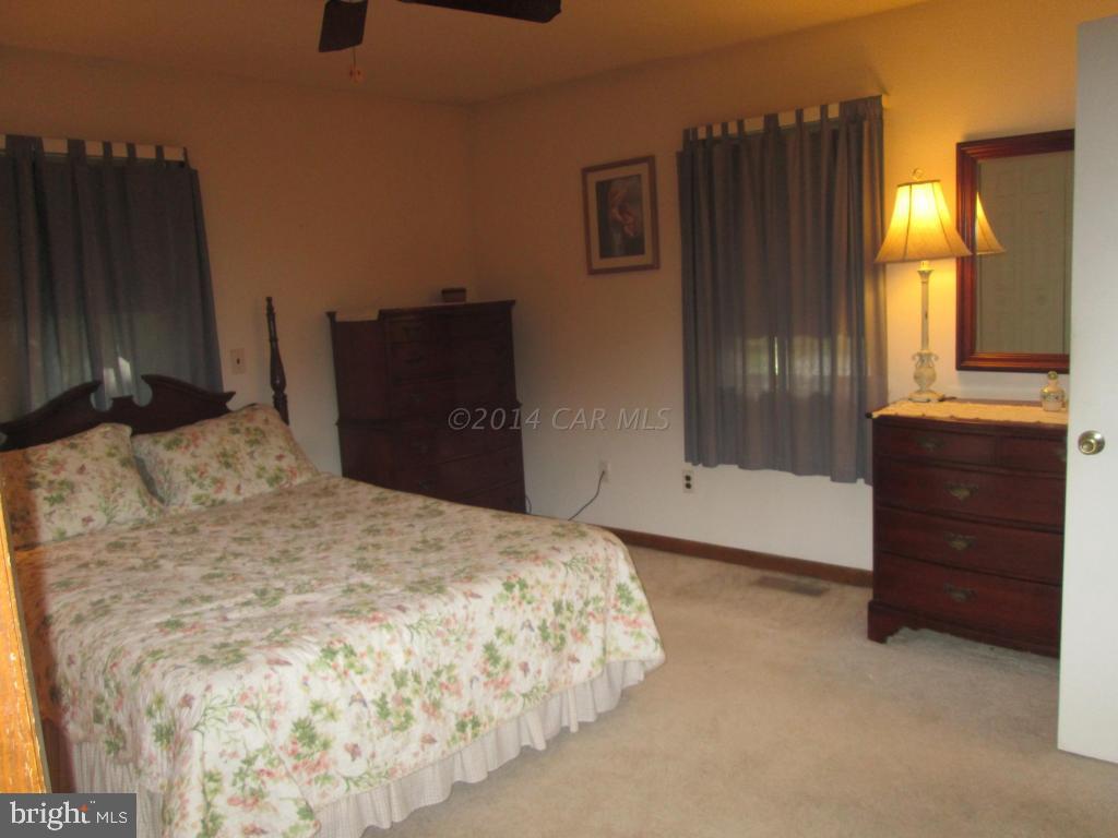 165 Windjammer Road Berlin, MD 21811 - Photo 16 of 26 a bedroom with a bed and a dresser