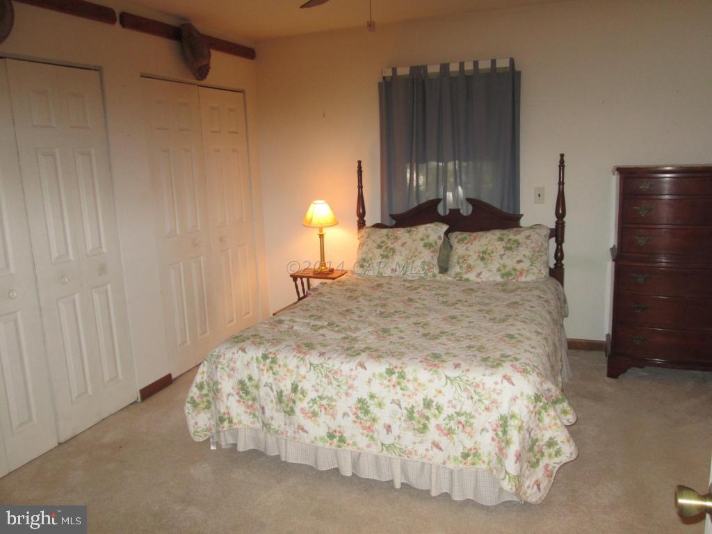 165 Windjammer Road Berlin, MD 21811 - Photo 17 of 26 a bedroom with a bed and a night stand