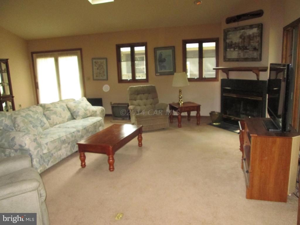 165 Windjammer Road Berlin, MD 21811 - Photo 22 of 26 a living room with furniture and a fireplace