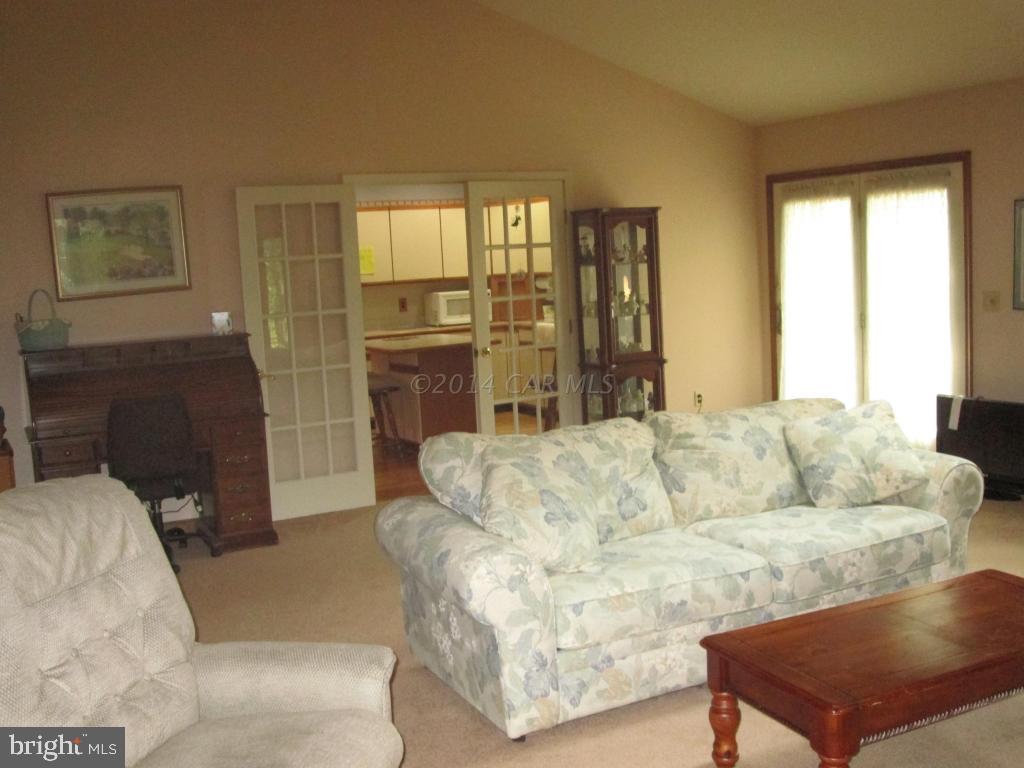 165 Windjammer Road Berlin, MD 21811 - Photo 23 of 26 a living room with furniture and a fireplace