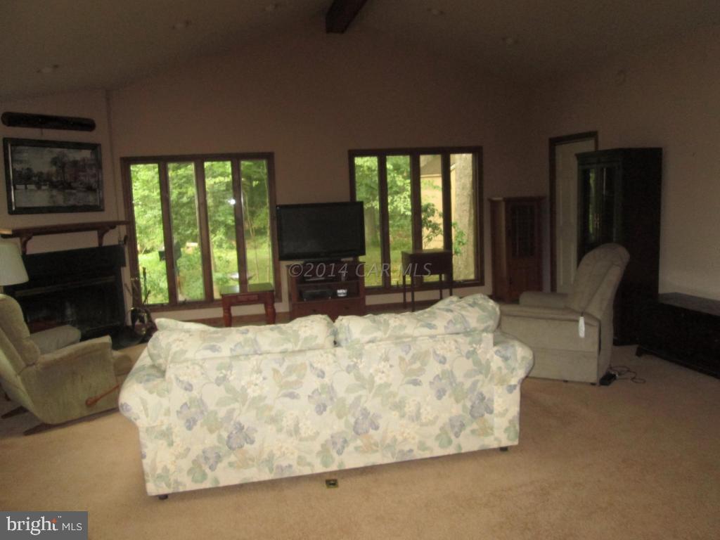 165 Windjammer Road Berlin, MD 21811 - Photo 6 of 26 a bed sitting in a spacious bedroom next to a window with a flat screen tv