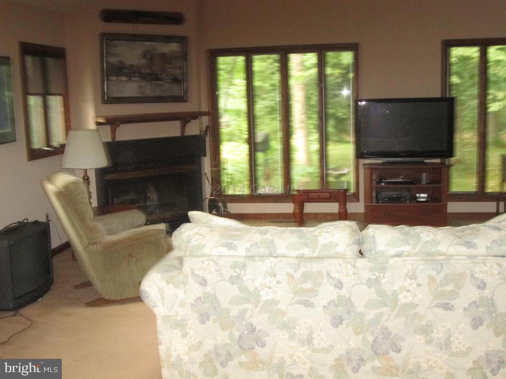 165 Windjammer Road Berlin, MD 21811 - Photo 7 of 26 a living room with a flat screen tv and a fireplace