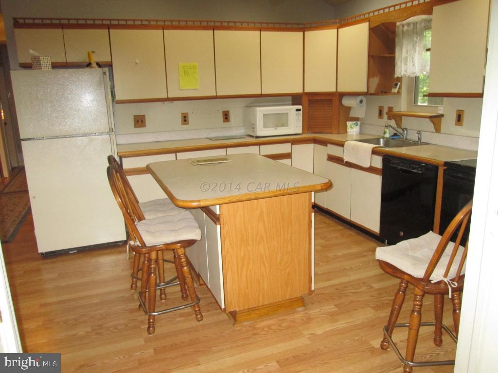 165 Windjammer Road Berlin, MD 21811 - Photo 10 of 26 a kitchen with a sink a stove and white cabinets