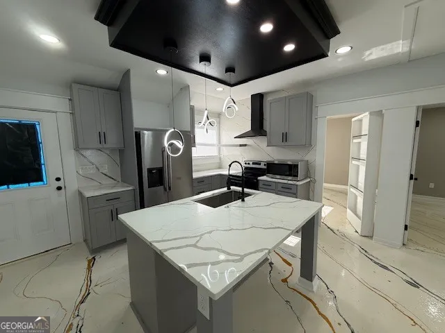 a kitchen with stainless steel appliances granite countertop a sink refrigerator and cabinets