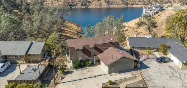 an aerial view of a house with a lake view