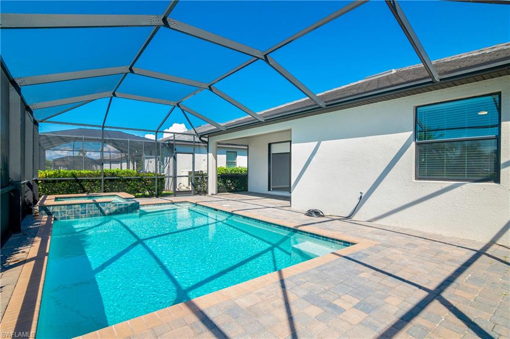 19952 Beverly Park Road Estero, FL 33928 - Photo 21 of 32 a view of a backyard with swimming pool and sitting area