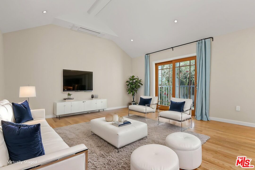 652 Kensington Road, Unit B Santa Monica, CA 90405 - Photo 4 of 15 a living room with furniture and a flat screen tv