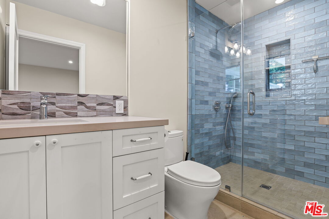 652 Kensington Road, Unit B Santa Monica, CA 90405 - Photo 9 of 15 a bathroom with a sink a toilet and shower