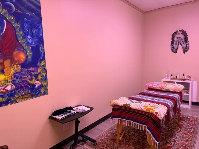 a bedroom with a bed and a wall painting