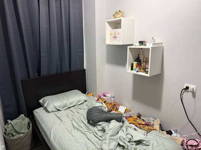 a bedroom with a bed and a window