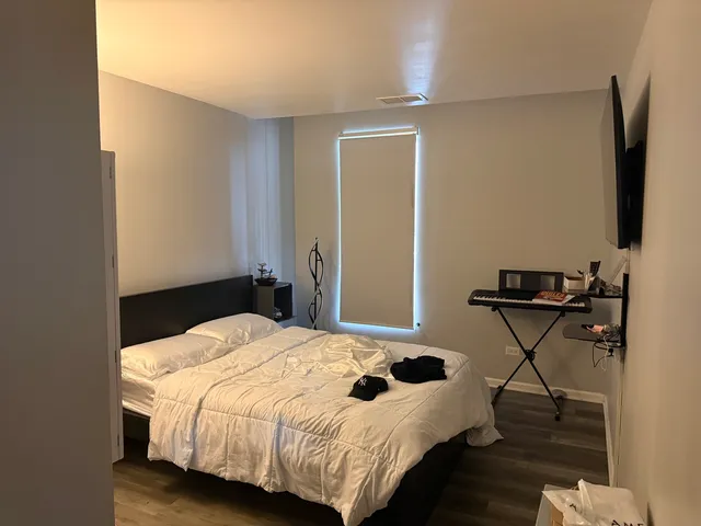 a bedroom with a bed and a flat screen tv