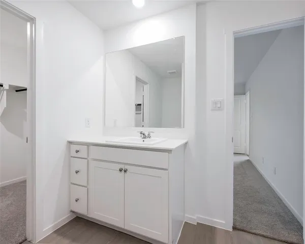 a bathroom with a double vanity sink and mirror