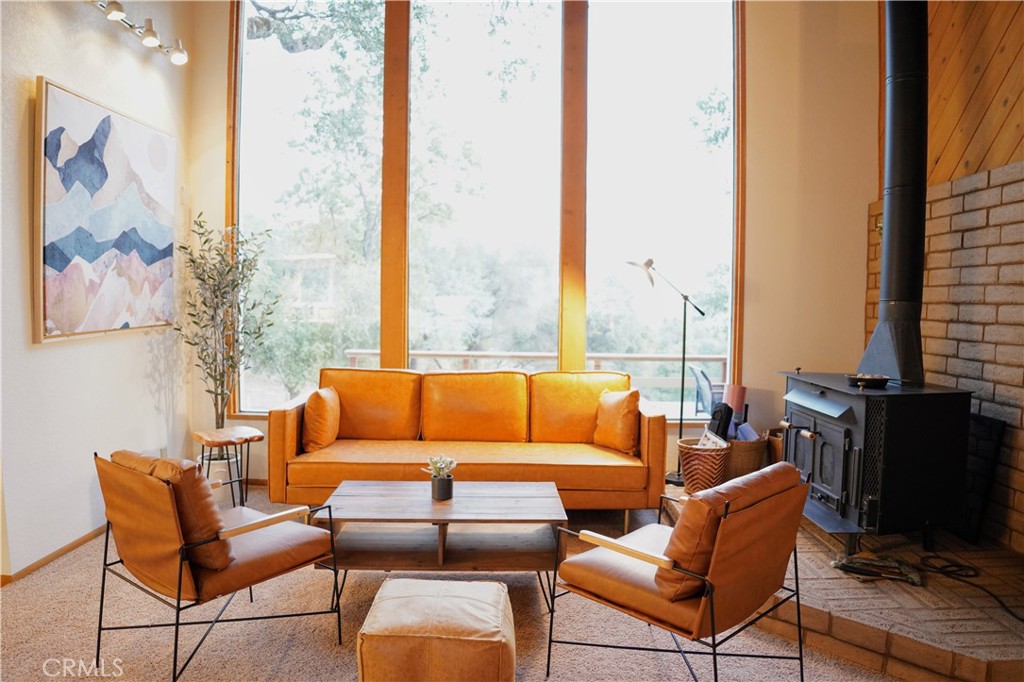 a blue couch sitting in front of a large window with a view of chair