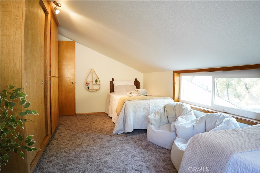 40659 Indian Springs Road Oakhurst, CA 93644 - Photo 16 of 28 a spacious bedroom with a bed and a couch