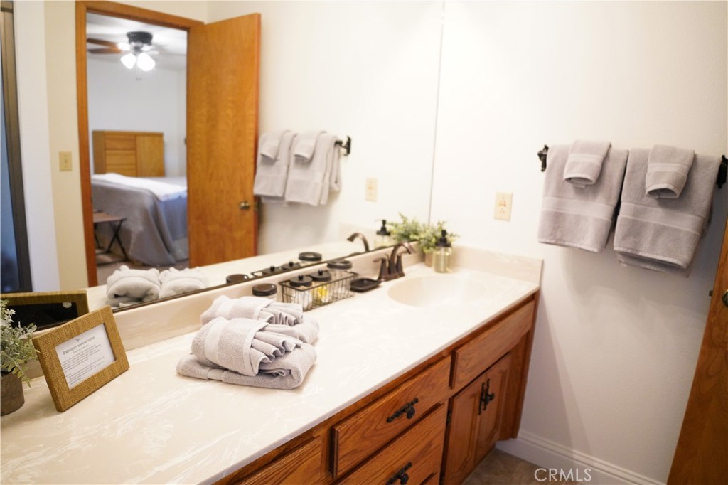 40659 Indian Springs Road Oakhurst, CA 93644 - Photo 19 of 28 a bathroom with a double vanity sink and a mirror