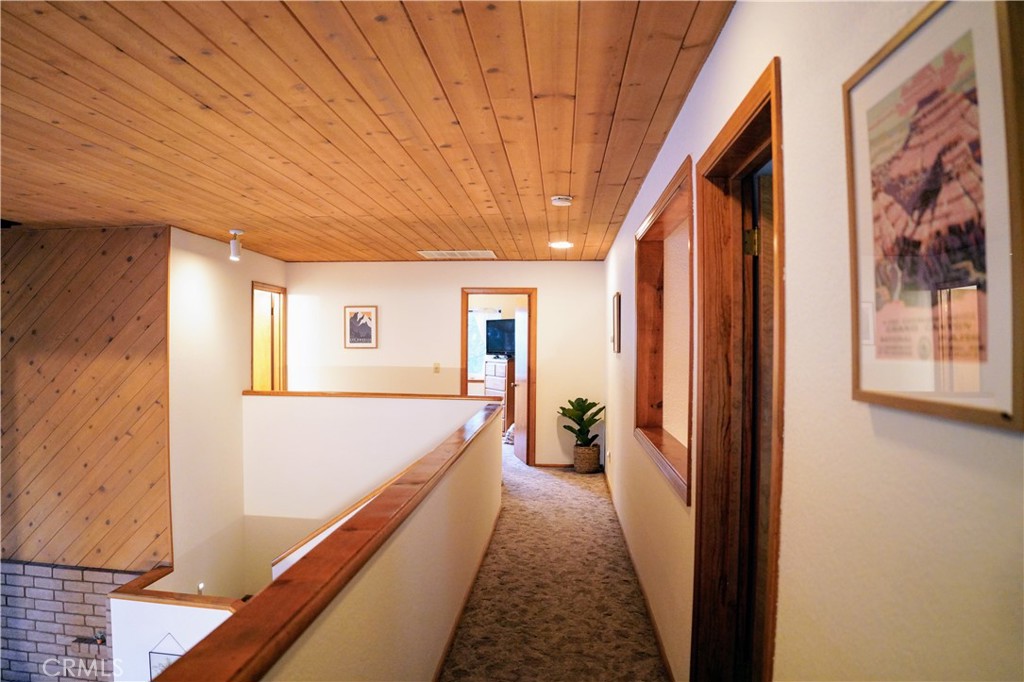 40659 Indian Springs Road Oakhurst, CA 93644 - Photo 25 of 28 a view of hallway with furniture and a window