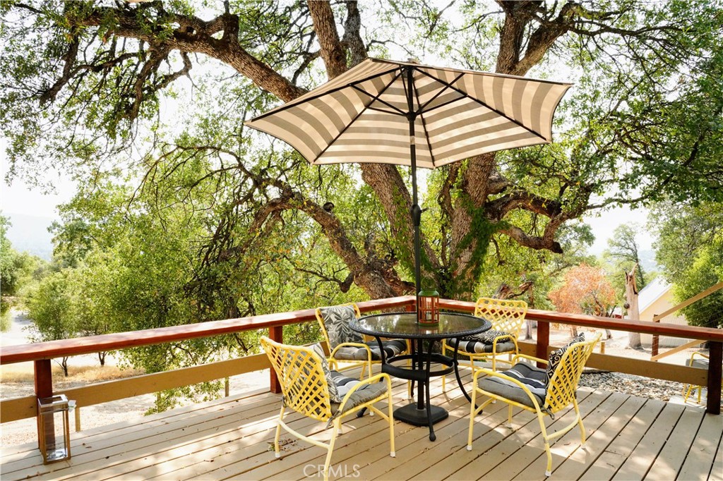 40659 Indian Springs Road Oakhurst, CA 93644 - Photo 6 of 28 a view of balcony with wooden floor and outdoor seating