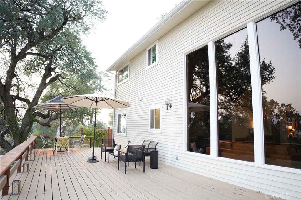 40659 Indian Springs Road Oakhurst, CA 93644 - Photo 7 of 28 a view of a house with backyard porch and sitting area