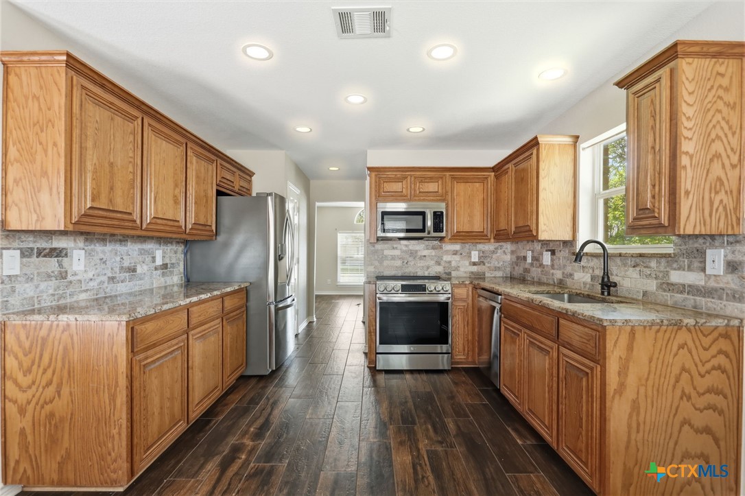 2208 Stonecrest Path New Braunfels, TX 78130 - Photo 5 of 23 Granite countertops and new backsplash recently updated