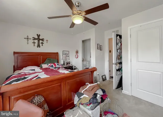 a bedroom with bed and a chandelier