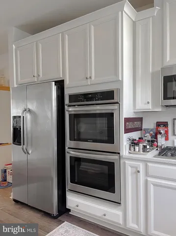 a kitchen with cabinets and stainless steel appliances