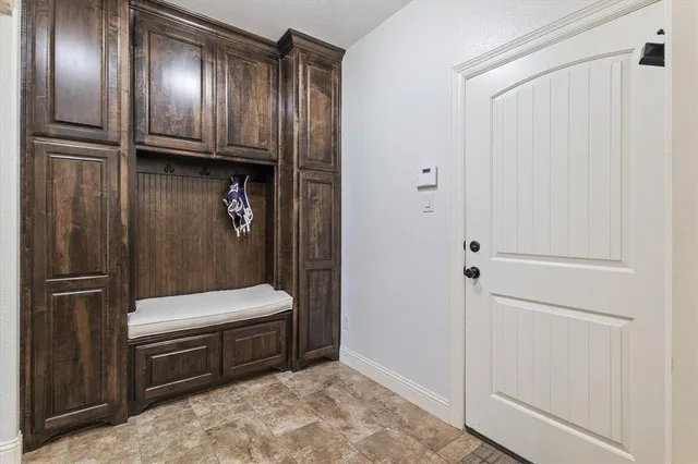 a view of a hallway with a livingroom and a chandelier
