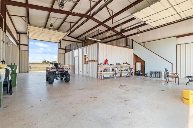 a bedroom with a bed dresser and a dining table with wooden floor
