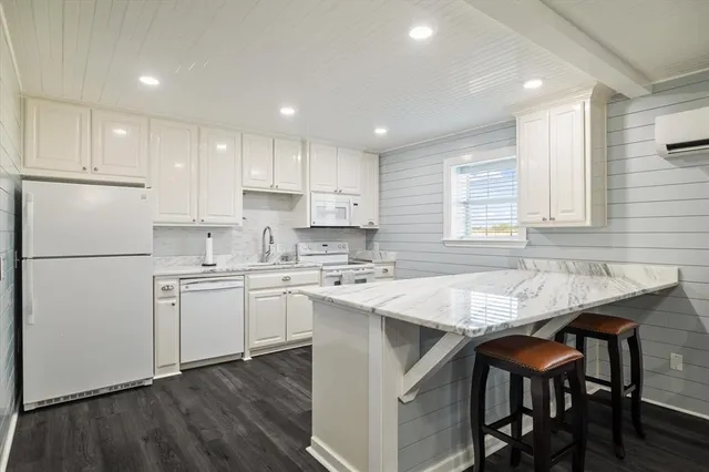 a bathroom with a shower toilet and sink