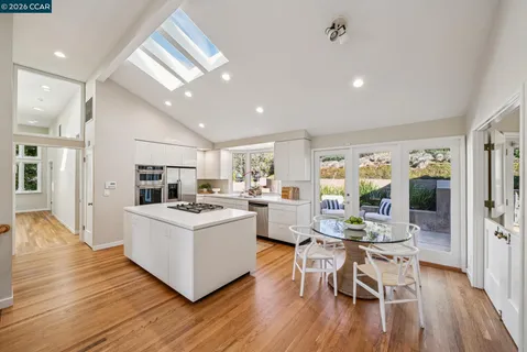 a kitchen with stainless steel appliances a stove a sink and a refrigerator