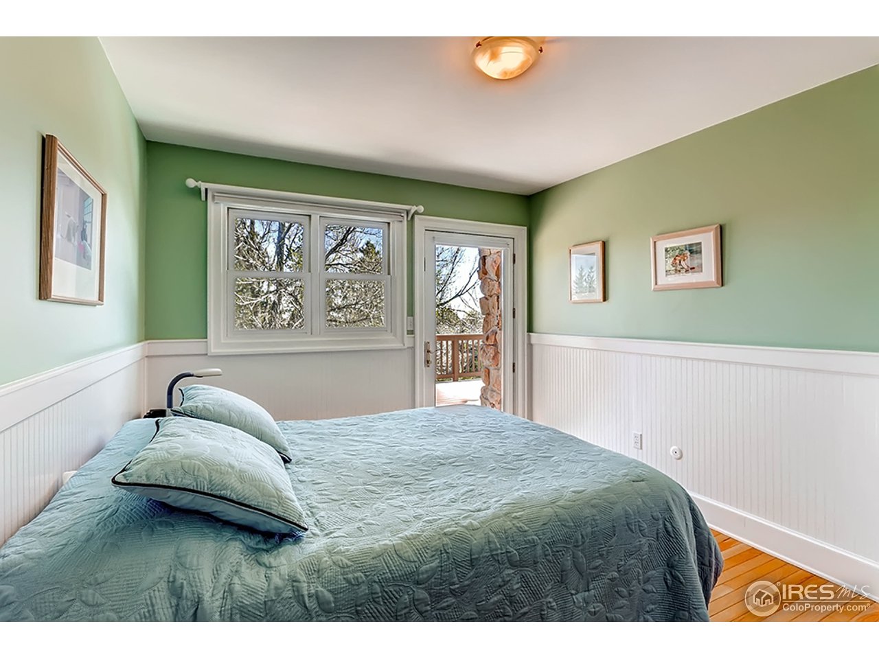 1715 View Point Road Boulder, CO 80305 - Photo 16 of 33 a bedroom with a bed and a painting on the wall