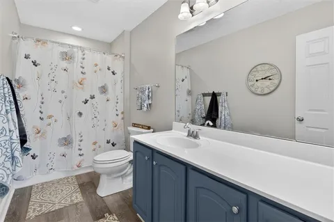 a bathroom with a sink toilet and shower