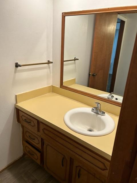 6111 38th Street, Unit B Lubbock, TX 79407 - Photo 6 of 9 a bathroom with a sink and a mirror