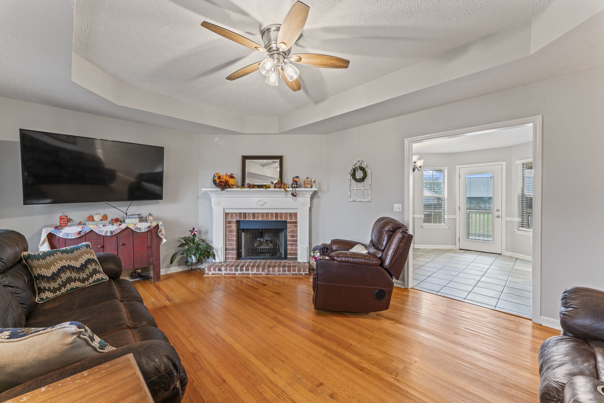 3591 April Lane Murfreesboro, TN 37130 - Photo 6 of 38 a living room with furniture a flat screen tv and a fireplace