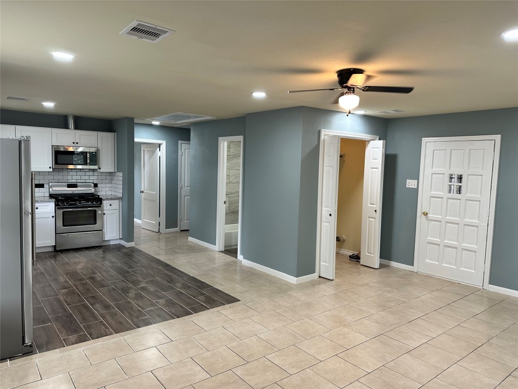 6911 Bauman Road Houston, TX 77022 - Photo 6 of 17 a view of a kitchen with a sink and a refrigerator