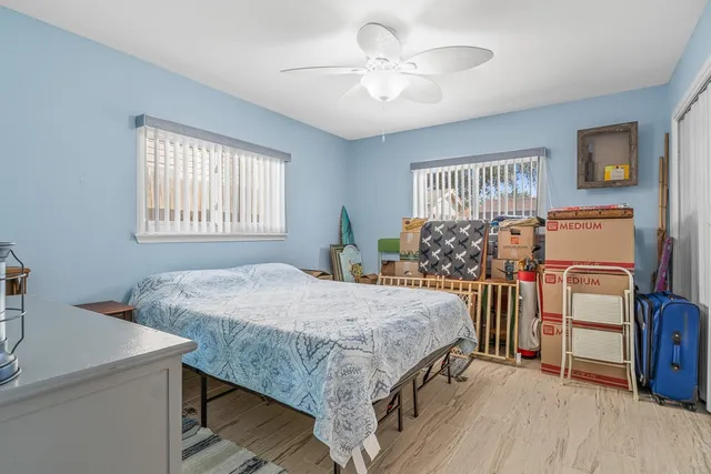a bed sitting in a bedroom next to a window