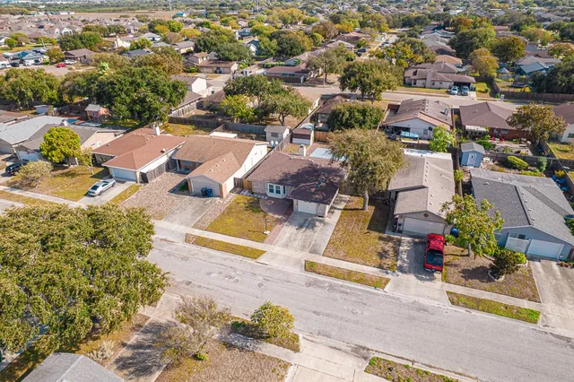 an aerial view of residential houses with outdoor space