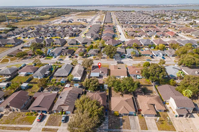 an aerial view of residential houses with outdoor space