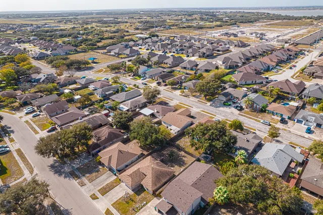 an aerial view of residential houses with outdoor space