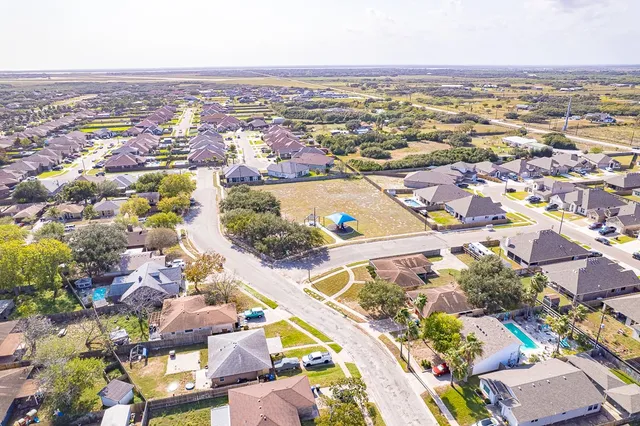 an aerial view of residential houses with outdoor space