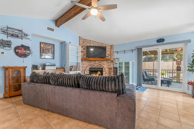 a living room with a bed furniture and a flat tv screen