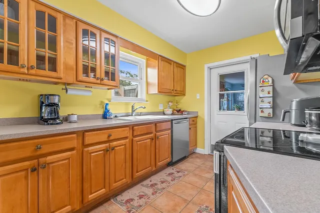 a kitchen with stainless steel appliances granite countertop a sink and cabinets