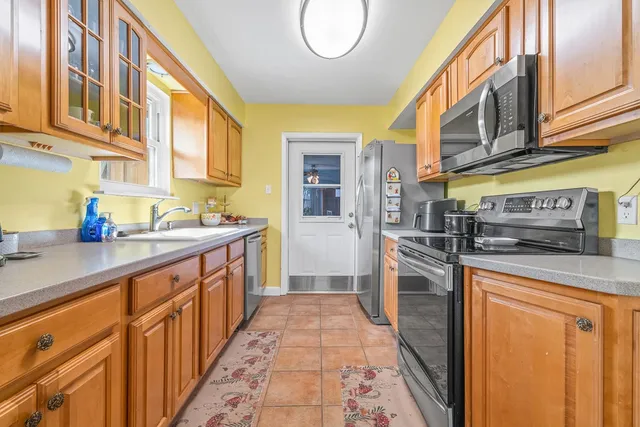 a kitchen with stainless steel appliances granite countertop a sink and cabinets