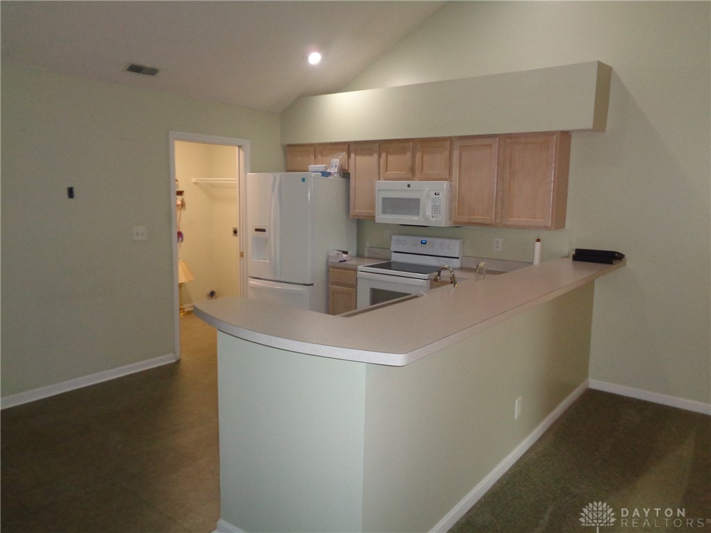 80 Villa Pointe Drive Springboro, OH 45066 - Photo 8 of 19 This functional kitchen features a breakfast bar, ample storage, and vaulted ceilings.