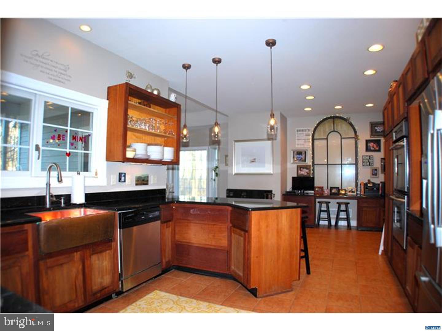 835 Pennock Bridge Road Landenberg, PA 19350 - Photo 14 of 25 a kitchen with stainless steel appliances kitchen island granite countertop a stove a sink dishwasher and a microwave