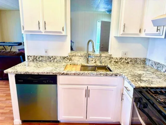 a kitchen with a stove and a window