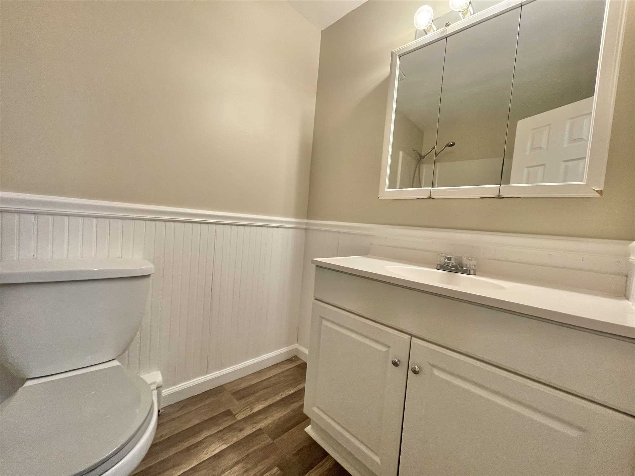 3 Hook Road, Unit 42A Poughkeepsie, NY 12601 - Photo 5 of 9 a bathroom with a sink a toilet and a mirror