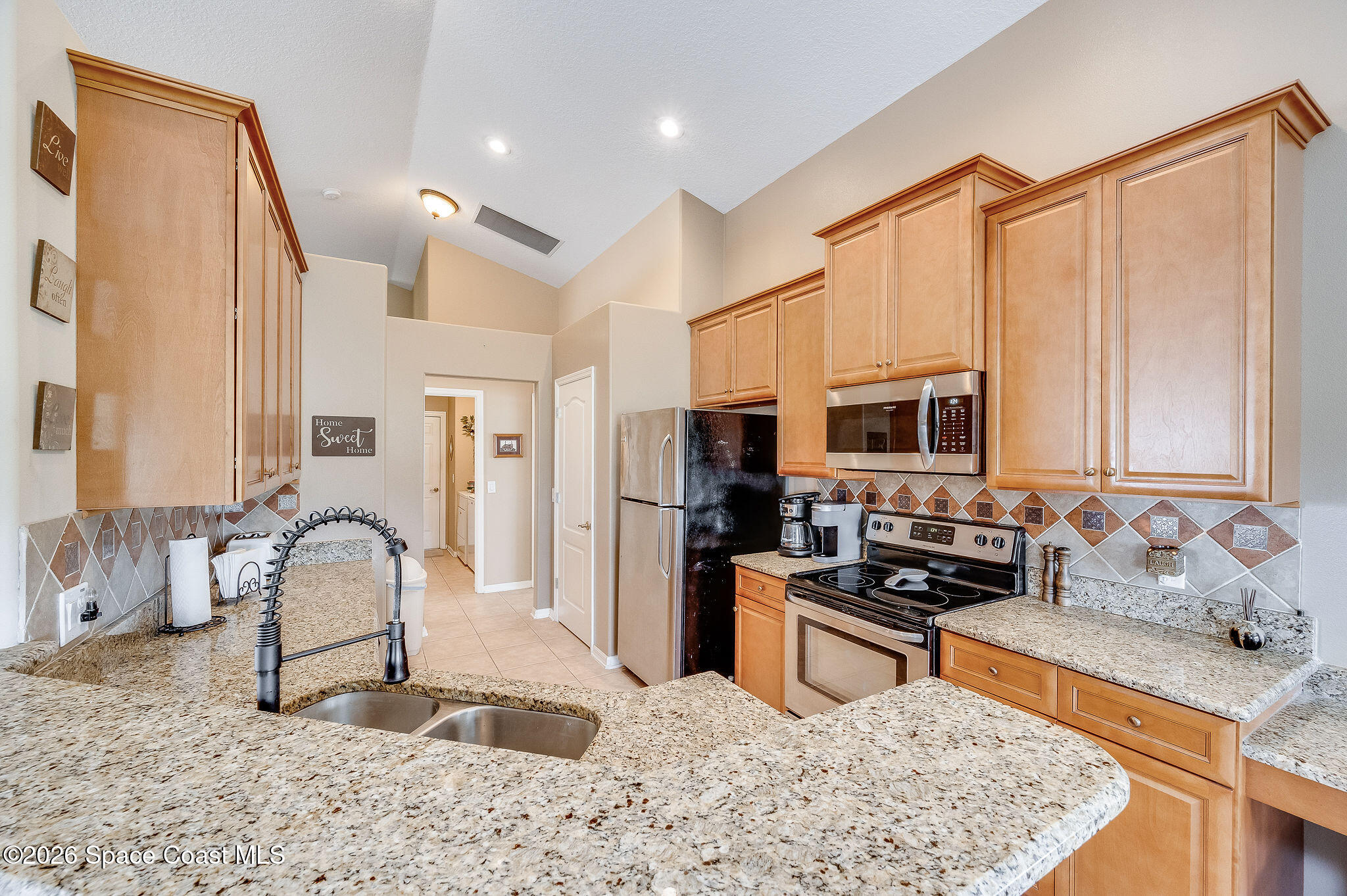 4910 Worthington Circle Rockledge, FL 32955 - Photo 14 of 69 a kitchen with stainless steel appliances granite countertop a sink stove and refrigerator